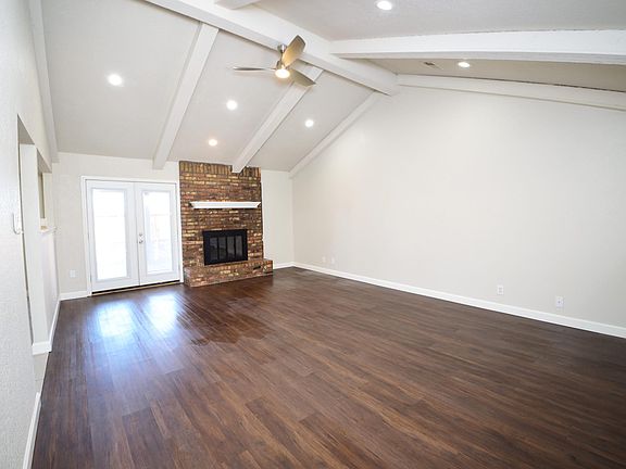 Living room with vaulted ceilings & fireplace.