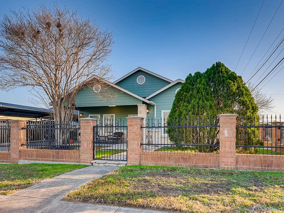 Front Exterior - corner lot, covered patio, and enclosed front yard and carport