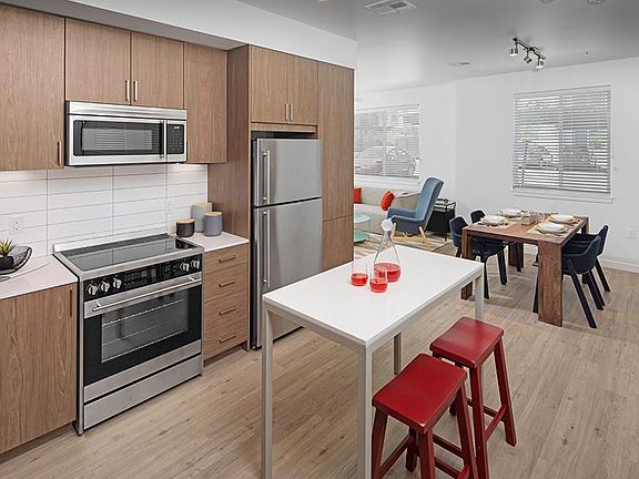 Hardwood-style flooring is featured throughout all entry, kitchen, living/dining and baths