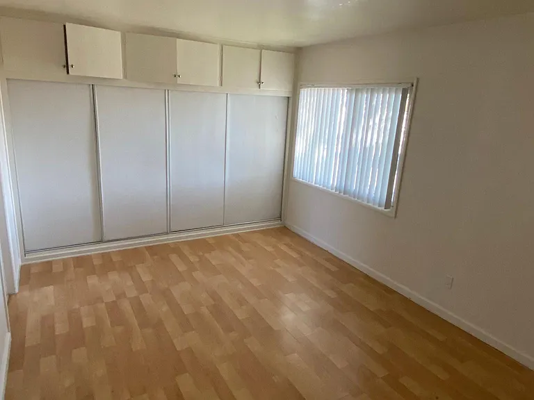 Bedroom with spacious closets and cupboards at Edison Apartments in Burbank, California.