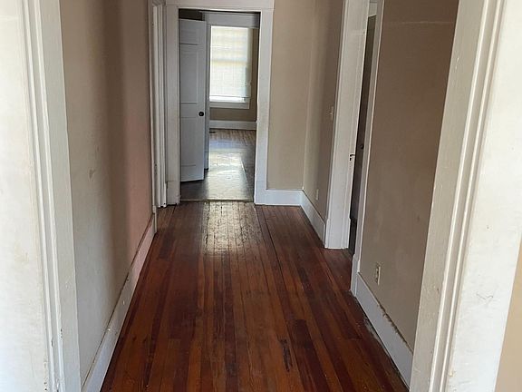 hallway that leads from the front door. On the right is a bedroom and on the left is a bedroom.