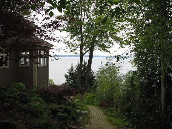 From front yard looking down the path to the backyard and stairs to the beach.