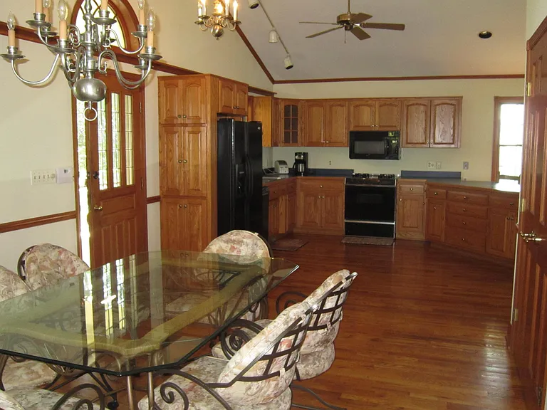 Dining Area and Kitchen w/ Front Door to left