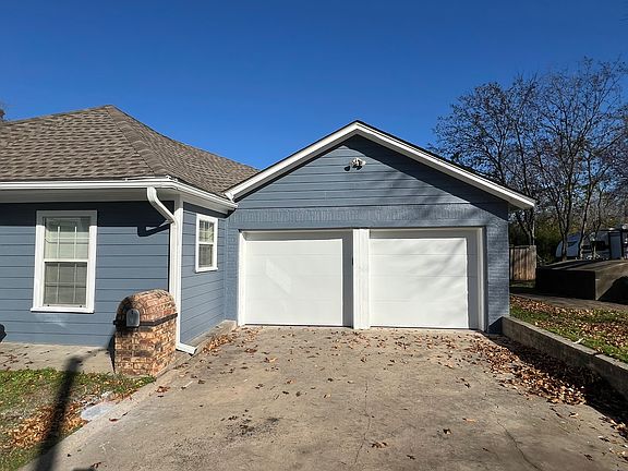 Back of the house, there is a two-car garage with driveway parking.