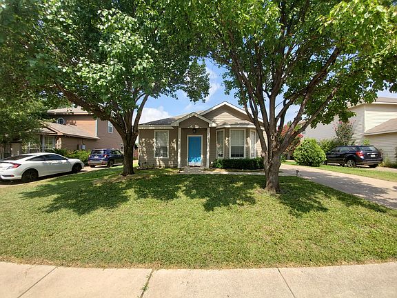 Street view of front, driveway on right. Large mature trees