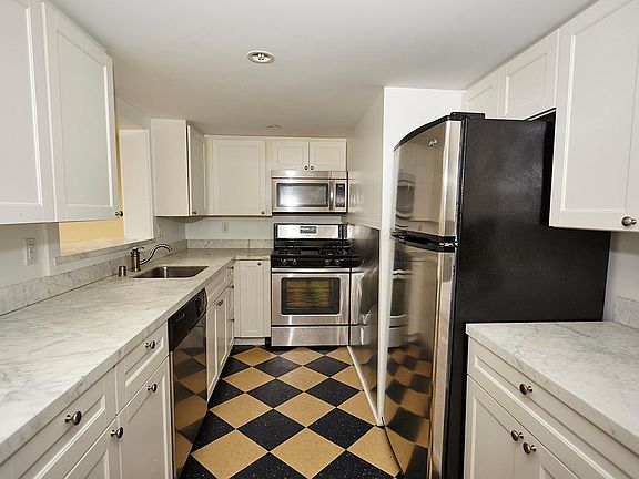 Kitchen with marble and stainless appliances