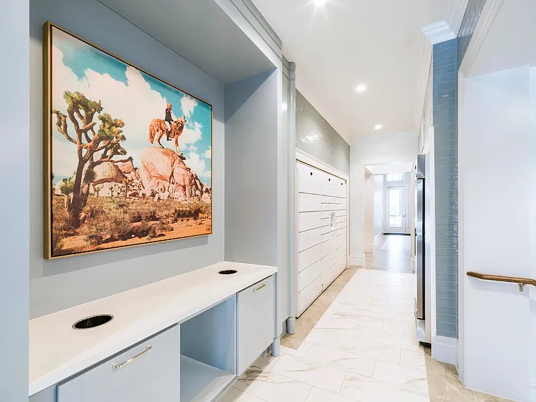 Community mail and package room with built-in counters and organized lockers creates a polished arrival point for daily deliveries.