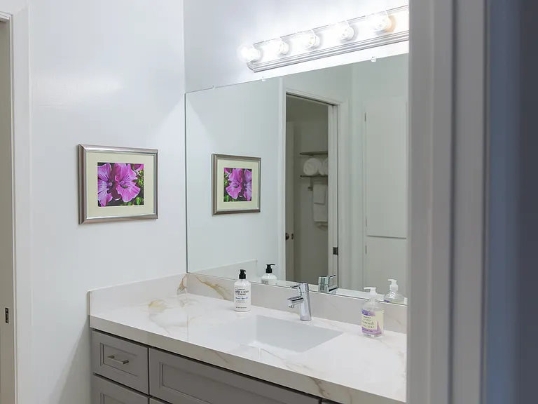 Vanity and sink area for second bedroom. Shower and toilet is to the left of it.