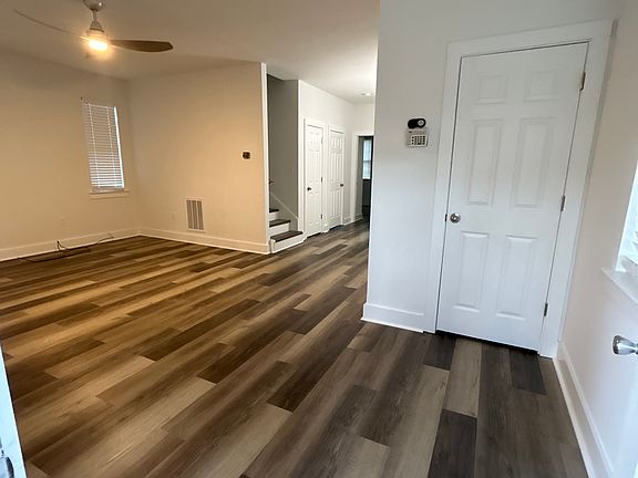 Enter into spacious living room and coat closet