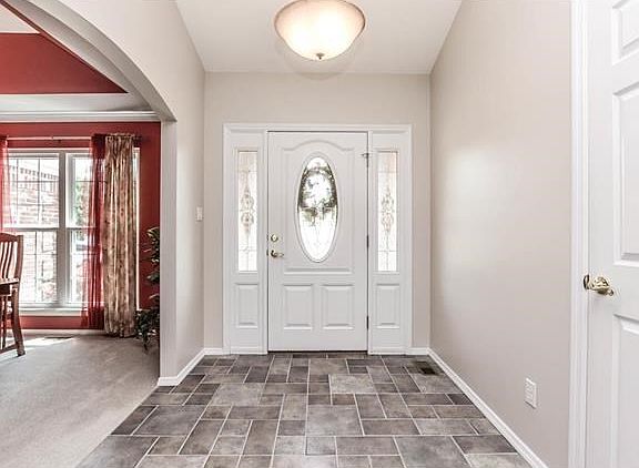 Charming light filled entryway with tile flooring.
