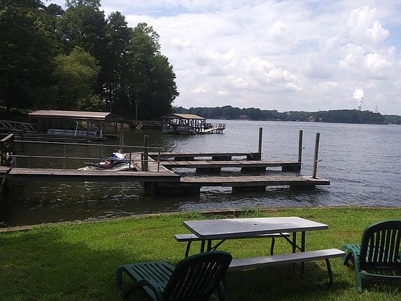 HERE ARE THE DOCKS WHERE YOU CAN TIE UP YOUR BOAT FREE. DOCKS LIKE THIS RENT AT MARINAS FOR UP TO $500/MO. HERE'S ANOTHER PICNIC TABLE (WE HAVE THREE) WHERE YOU CAN HAVE A COOKOUT; THERE'S A GRILL ON THE END OF THE PIER. THAT'S A 2 MILE VIEW TO CATAWBA C