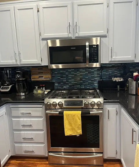 Newly painted cabinets and gas stove with convection oven for exquisite baking and cooking.