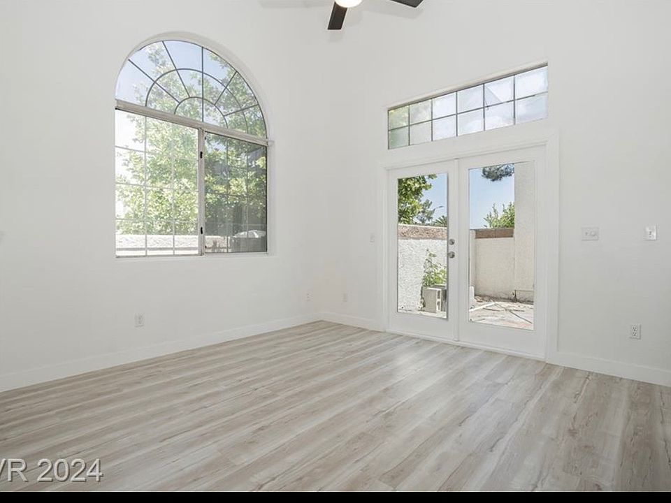 entryway, living room with fireplace and backyard access