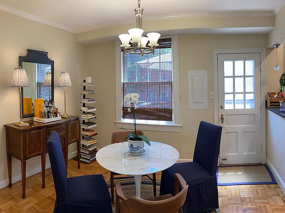 The dining room has a pretty chandelier, hardwood floor and access to the deck.