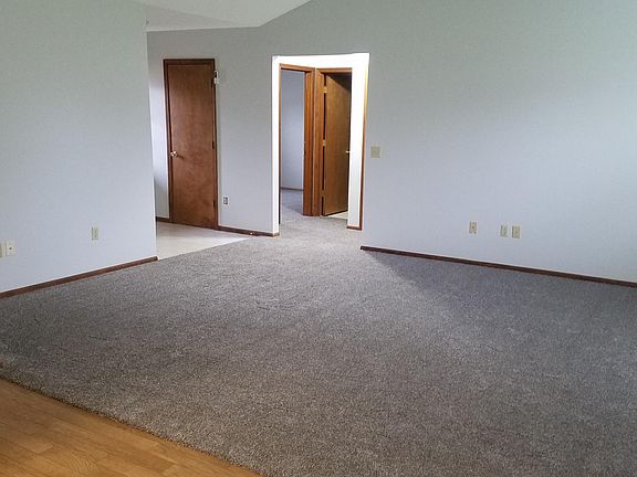 View from eat-in area to front door, bedroom 2 and 3, and full bath