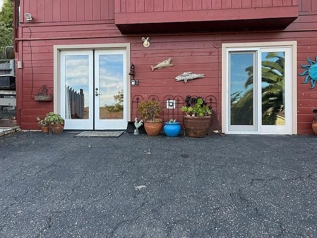 exterior of one bedroom apartment. Living room and entry through left door, bedroom through right door.