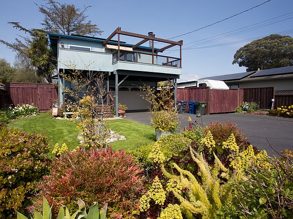 Beach house style home (Living, Kitchen, Primary bedroom, Primary bathroom on second floor). Established gardens on watering system with gardening service included.