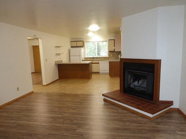 Open concept living, dining and cooking spaces! Lots of light with window above sink viewing green trees.