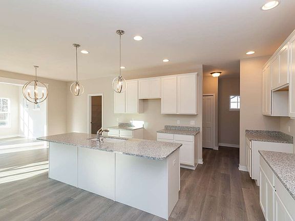 Bright airy kitchen boasts tons of cabinets and a massive walk in pantry