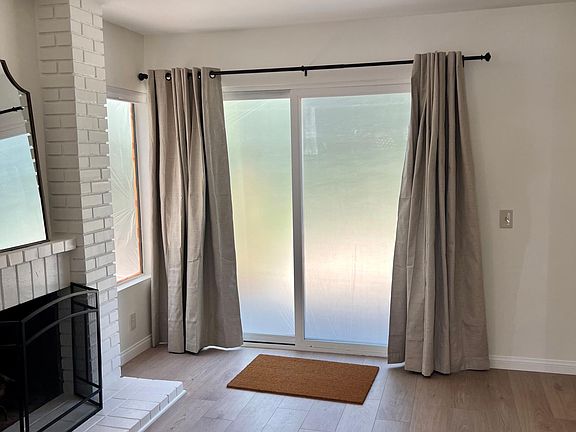 hearth room with slider to back yard. Window is covered due to exterior stucco work in this photo!