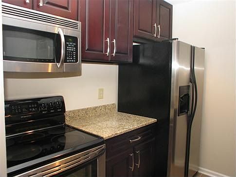 The renovated and inviting kitchen offers ample cabinet and counter space and brand new appliances including smooth top range, microwave, and a dishwasher.