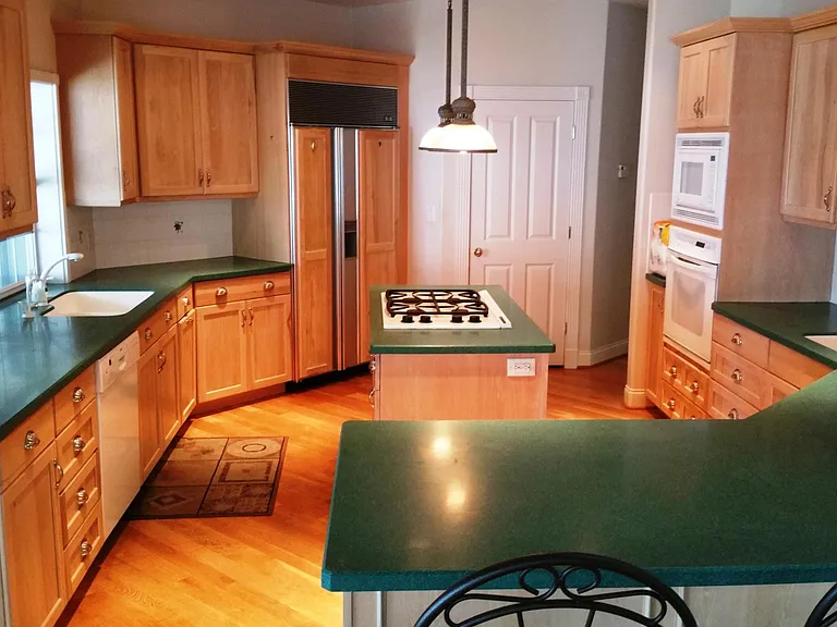 another view of the kitchen. The Sub Zero is next to the walk in pantry and the window on the left is a pass through to the main screened in porch with all overlooking the lake and pool deck.