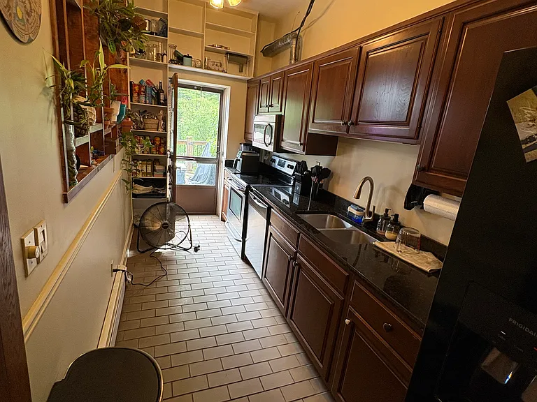 Galley Kitchen. Hole in the wall to your left. Good bet it leads to the dining room. But you don't have to climb through it, there is a door. Oh and the fridge is less than a year old.
