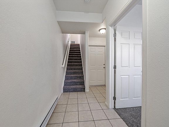 First floor garage entrance and to the left is a non conforming bedroom or a great office/den space.