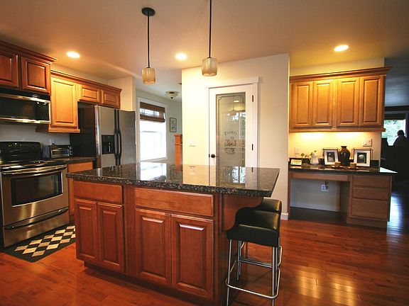 Breakfast bar on island, pantry and built-in desk