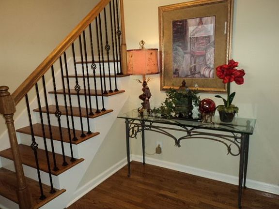 Entry foyer, new wood stair treads, railing and wrought iron spindles.