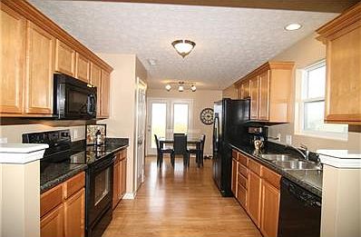 From the front door looking through the living room to the Kitchen, note great cabinets with crown molding.
