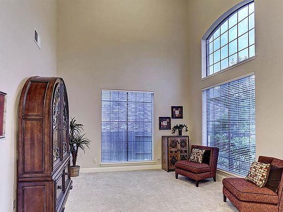 This flexible two story light and bright room would be a great office or game room downstairs.