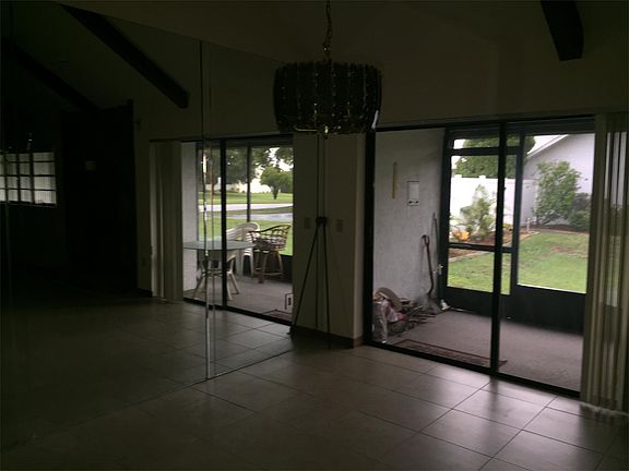 Sliding glass doors to the screened patio and the reflection in the mirrored wall