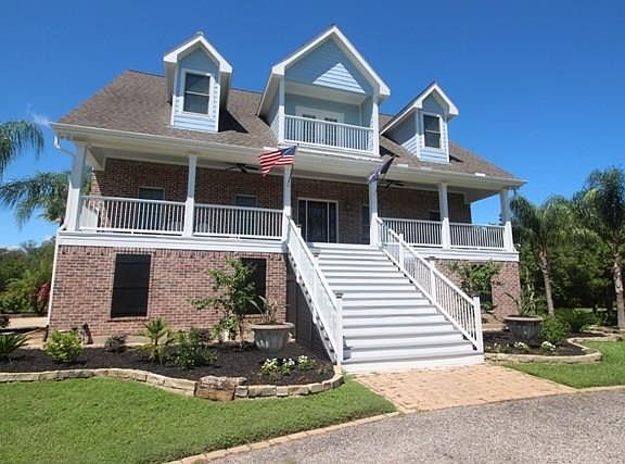Cape Cod charm and setting. Breezy balconies enjoy a bayview.