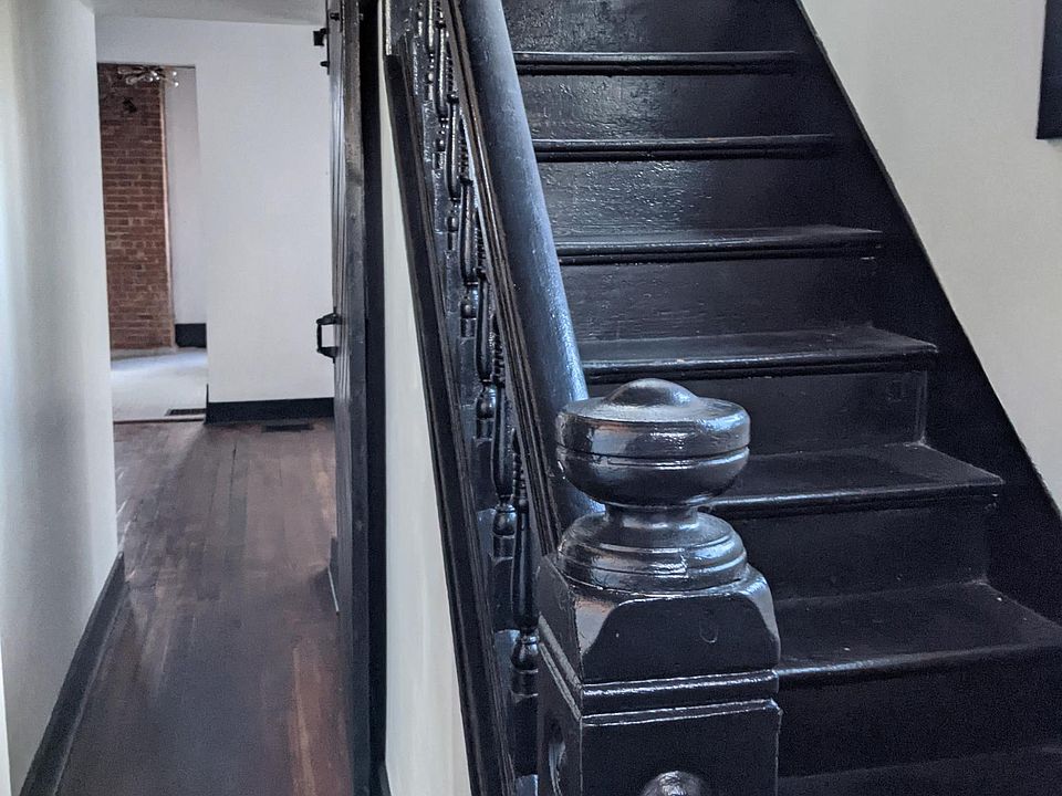 1st Floor - Foyer/Entryway. View of stairs up to 2nd floor, living room on left, dining room right ahead, view to kitchen. Original hardwood floors throughout main floor!