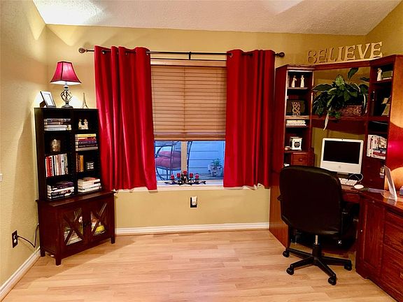 HOME OFFICE/STUDY- with a view of the front patio/deck It is open to the family room.