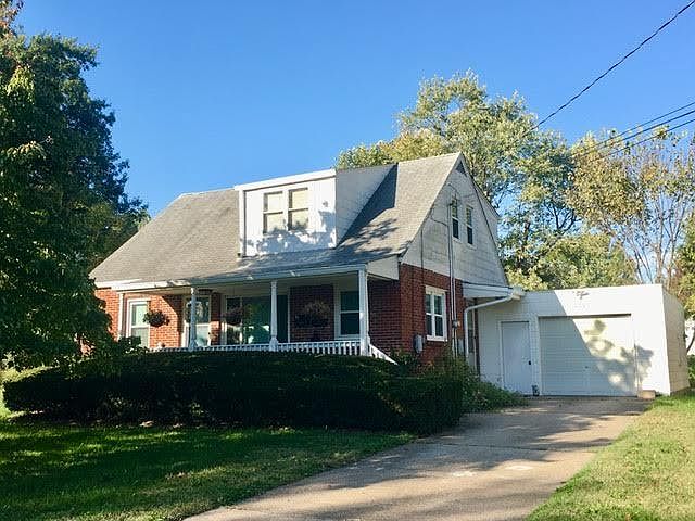House with upstairs apartment. Upper windows are in the living room.