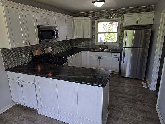 Kitchen stainless appliances. Stove/oven, refrigerator, Microwave, and dishwasher.