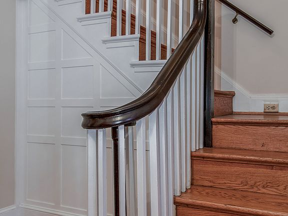 Graceful staircase with original wainscoting