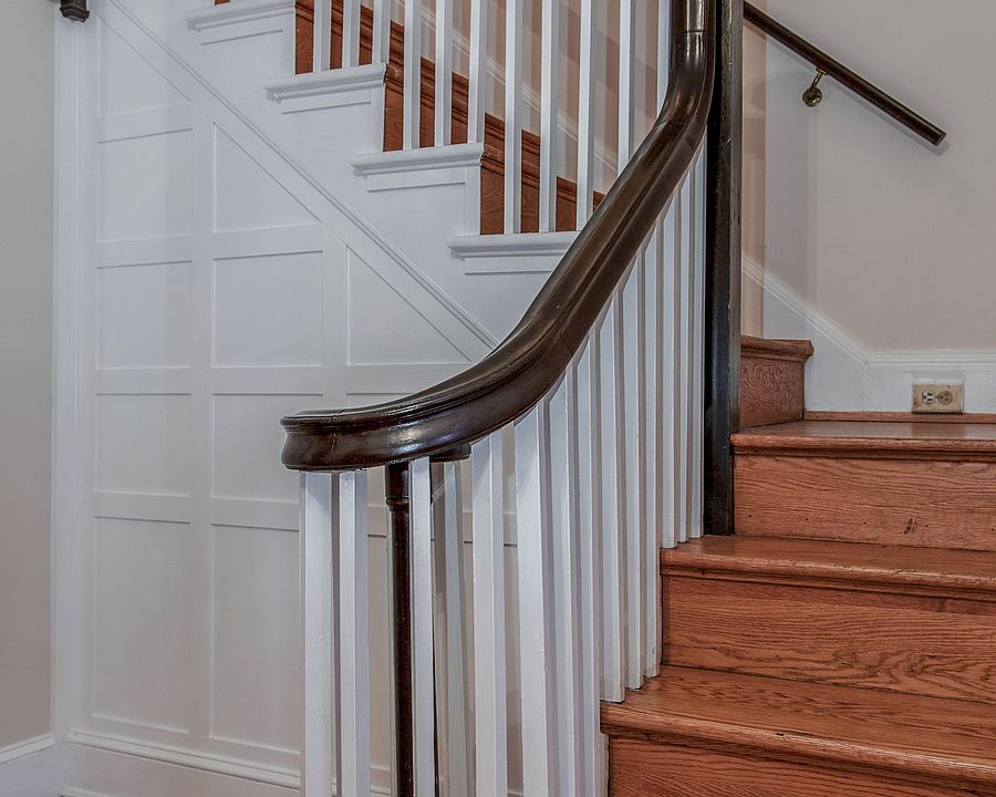 Graceful staircase with original wainscoting