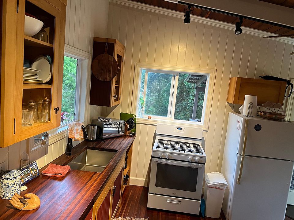 kitchen front door view west thru trees