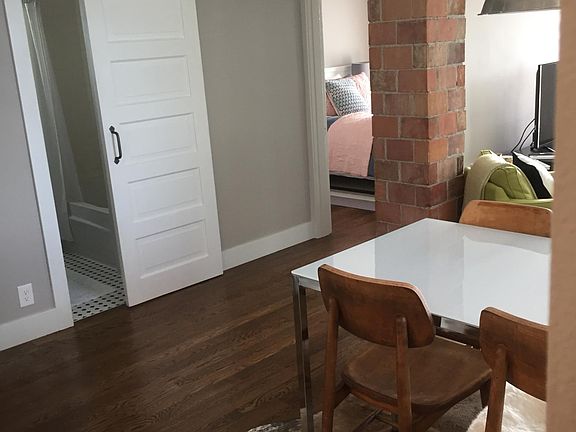 one small bathroom with tub and shower closes off with a barn door