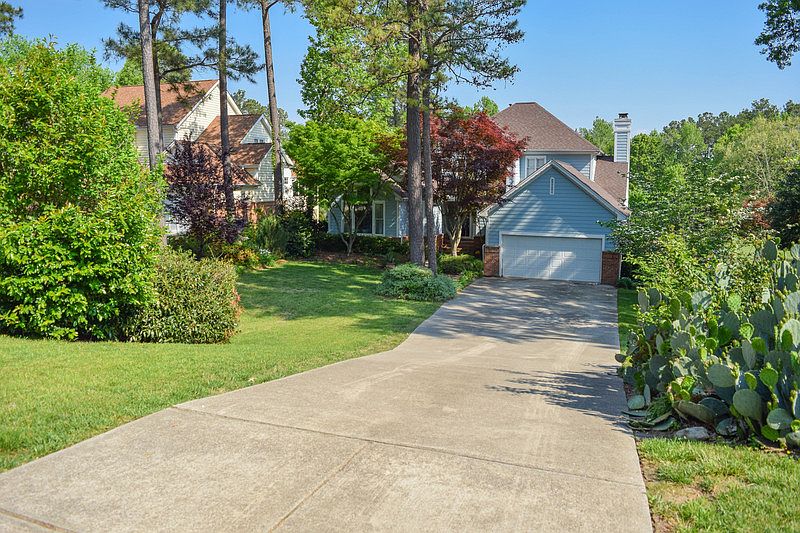 Front : Long driveway, lush mature landscape, 2 car garage