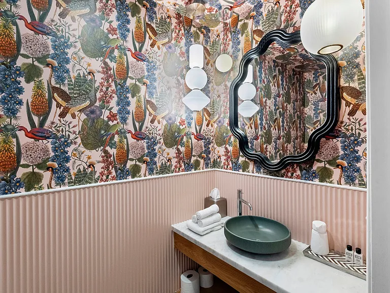 Elegant powder room with modern fixtures and a chic design, perfect for a refreshing touch-up during your stay.