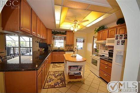 Tiled kitchen with upgraded cabinets and counter tops