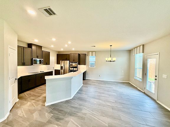Open concept kitchen/dining with contemporary finishes. Two tier kitchen island. Refrigerator conveys!