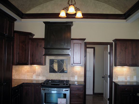 Custom tile backsplash above upgraded stainless stove