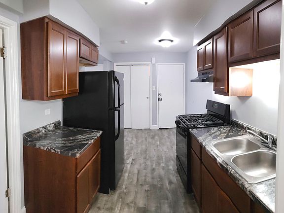 Brand New Kitchen Featuring Black Appliances
