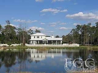View (from West to East) to the back of the home... from the Preserve end, across the pond, to the back of the home. There is an additional approx half  acre at this end of the pond... bring the 4 wheelers, pony and ride!  Large picket fenced yard, large front and back screened porchs make a great place to watch the sun rise and set!