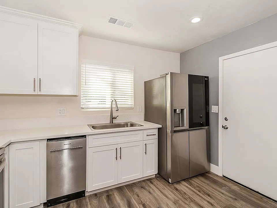 Updated Kitchen with Quartz Counter tops, high end appliances, LVP flooring, custom cabinets to the ceiling with soft close cabinets.